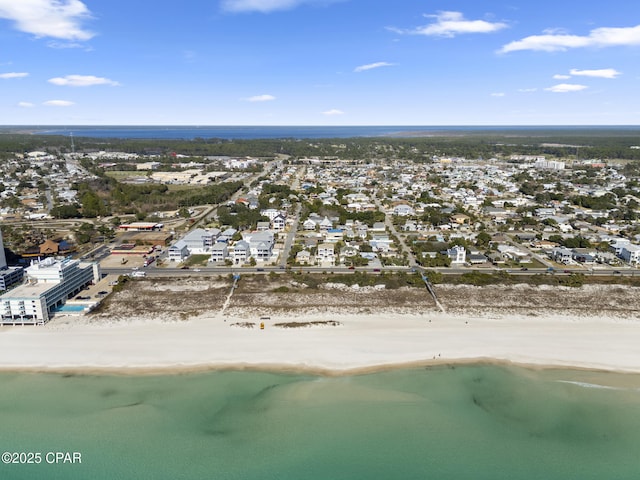 bird's eye view featuring a view of the beach, a water view, and a residential view