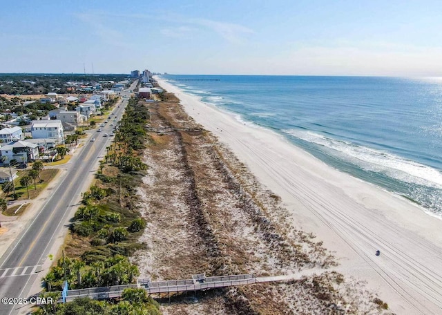 drone / aerial view with a beach view and a water view