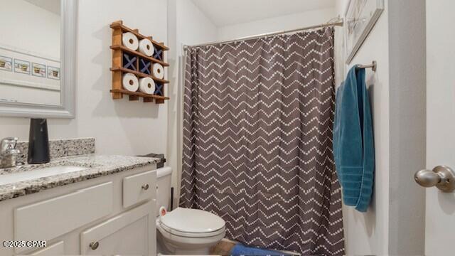 bathroom with vanity, toilet, and curtained shower