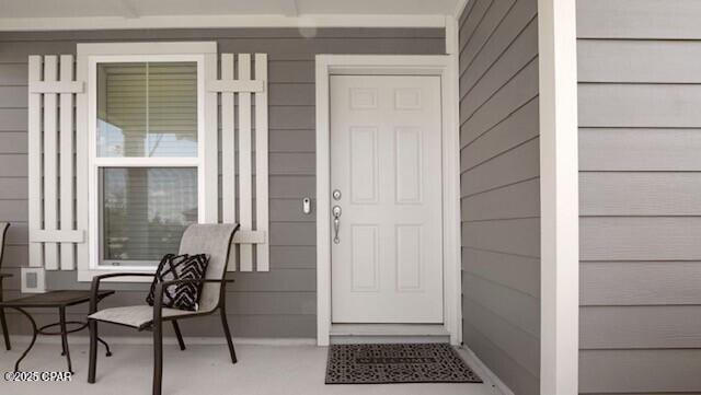 view of exterior entry with covered porch