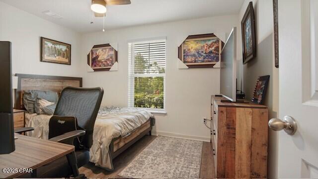 bedroom featuring hardwood / wood-style flooring and ceiling fan