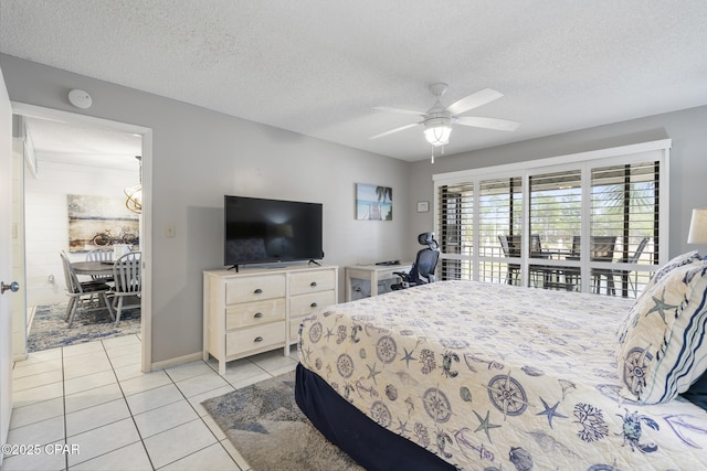 tiled bedroom featuring ceiling fan and a textured ceiling