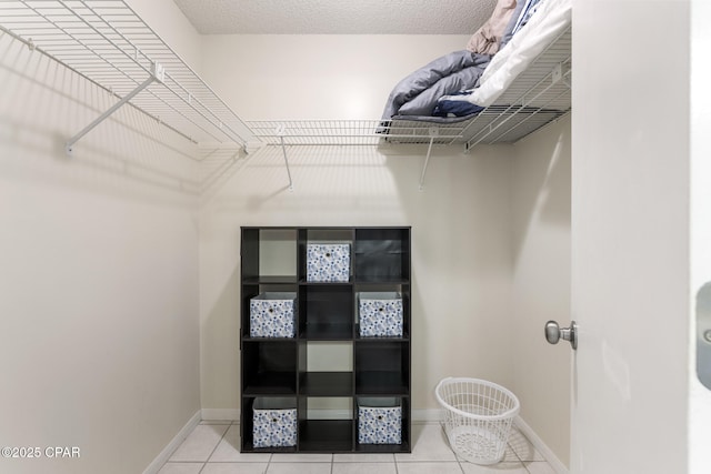 spacious closet with light tile patterned floors