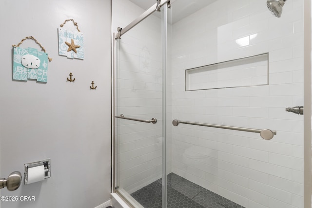 bathroom featuring a shower with shower door