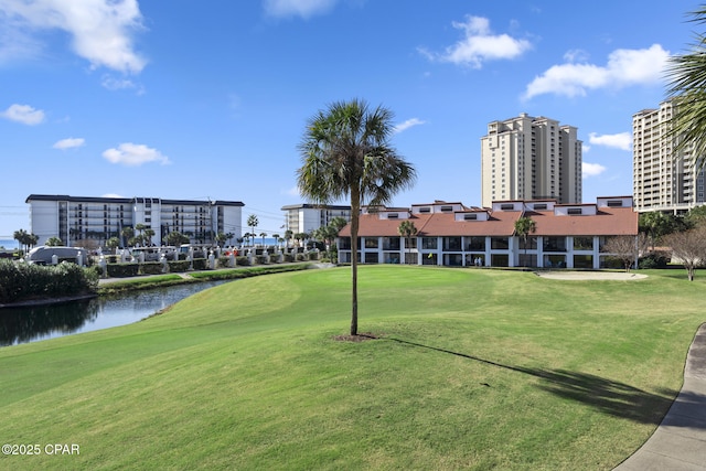 view of home's community featuring a water view and a yard