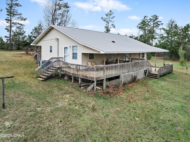 back of house featuring a wooden deck and a yard