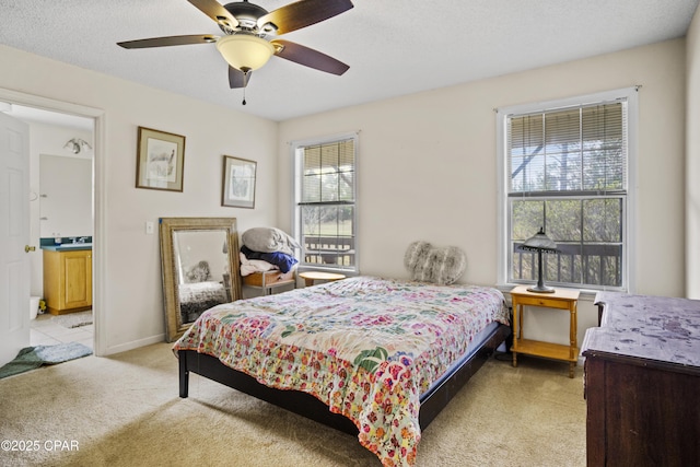 carpeted bedroom featuring ceiling fan and a textured ceiling