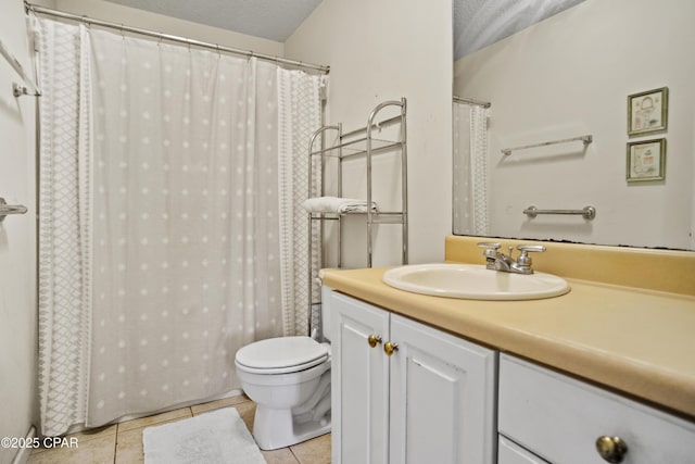 bathroom featuring tile patterned flooring, vanity, a textured ceiling, and toilet