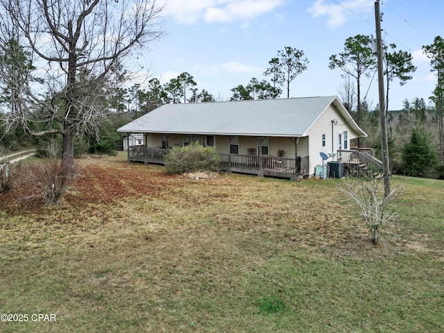 view of front of house featuring a front yard, central air condition unit, and a deck