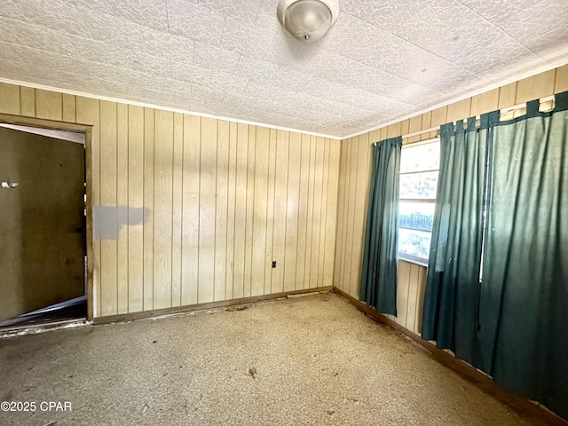 empty room featuring wooden walls