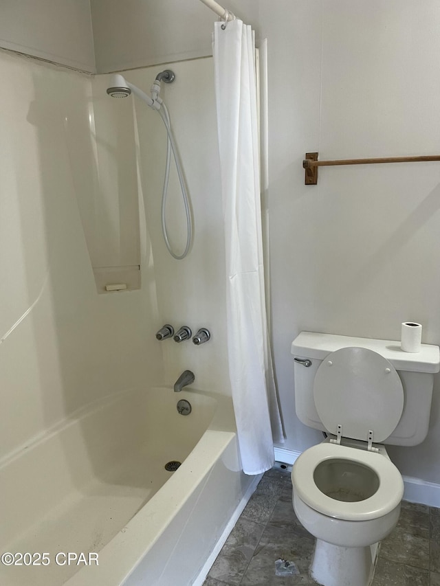 bathroom with shower / bath combination with curtain and toilet