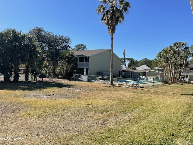 view of yard featuring fence and a community pool