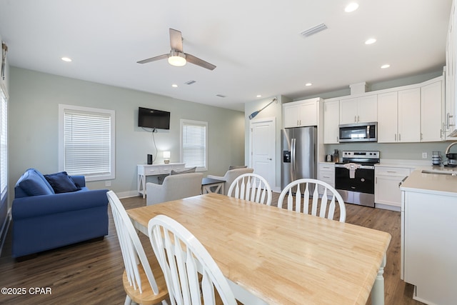 dining area with a ceiling fan, recessed lighting, visible vents, and dark wood-style flooring