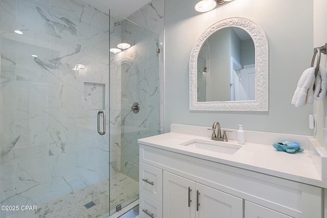bathroom featuring vanity and a shower stall