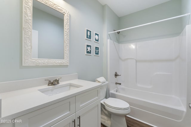full bath with vanity, bathing tub / shower combination, toilet, and wood finished floors