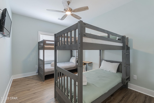 bedroom with baseboards, wood finished floors, and a ceiling fan