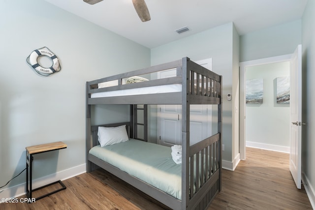 bedroom with visible vents, ceiling fan, baseboards, and wood finished floors