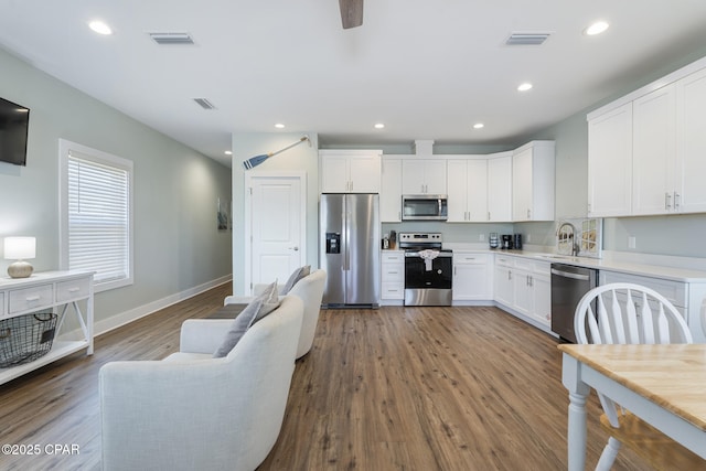 kitchen with a sink, stainless steel appliances, visible vents, and recessed lighting