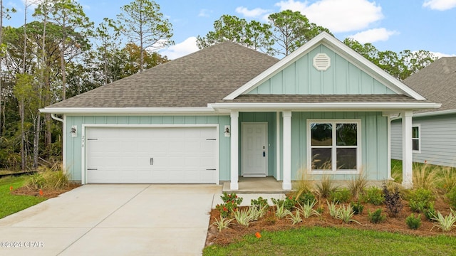 view of front of home with a garage, a shingled roof, board and batten siding, and concrete driveway