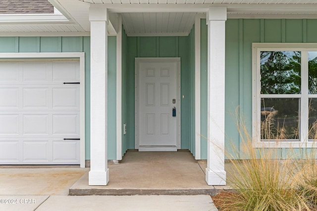 entrance to property with a shingled roof and board and batten siding