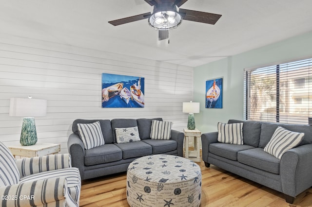 living room featuring ceiling fan and wood-type flooring