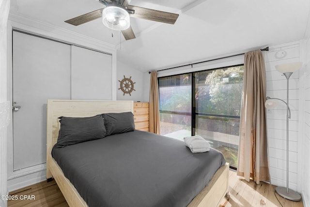 bedroom featuring ceiling fan, lofted ceiling, light hardwood / wood-style floors, and access to outside