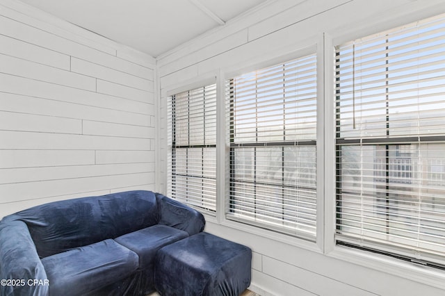 sitting room featuring wooden walls