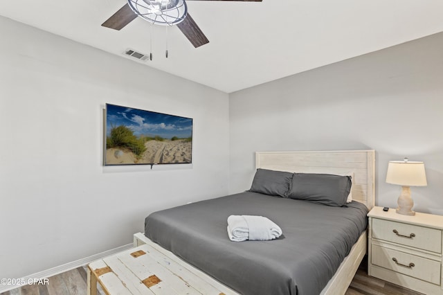 bedroom with dark wood-type flooring and ceiling fan