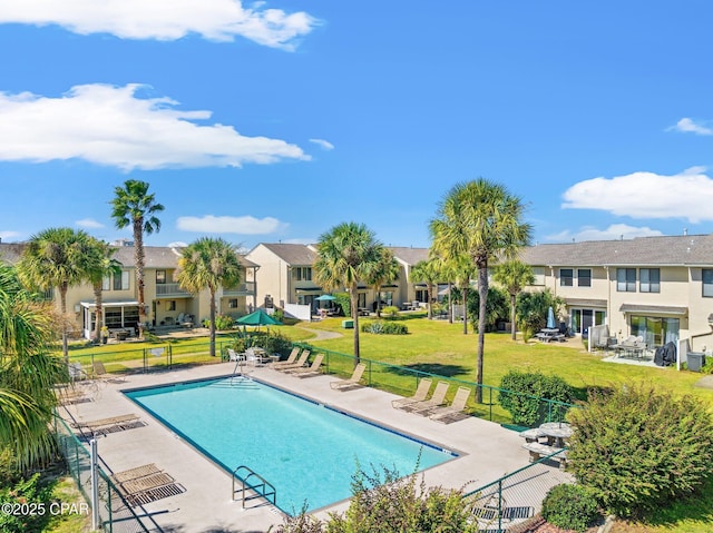 view of swimming pool with a patio area and a lawn