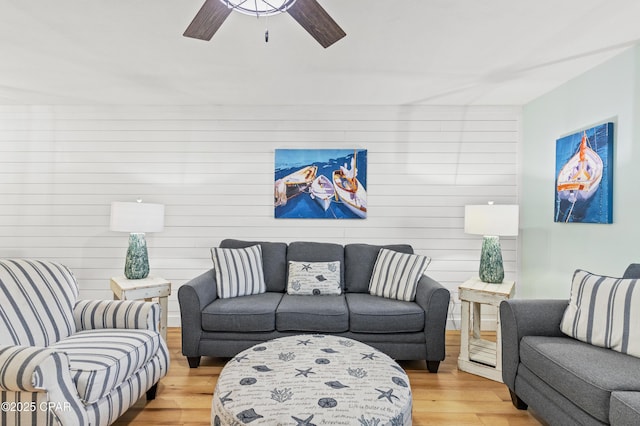 living room featuring hardwood / wood-style flooring and ceiling fan