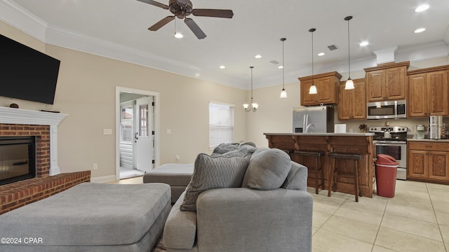 living area with crown molding, light tile patterned floors, recessed lighting, visible vents, and a brick fireplace