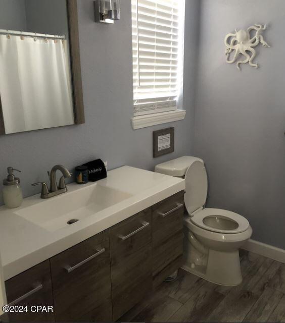 bathroom with vanity, hardwood / wood-style flooring, and toilet