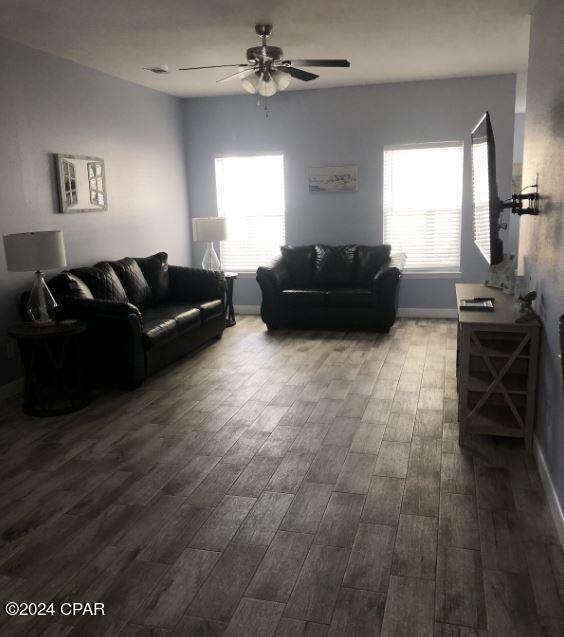 living room with hardwood / wood-style flooring and ceiling fan