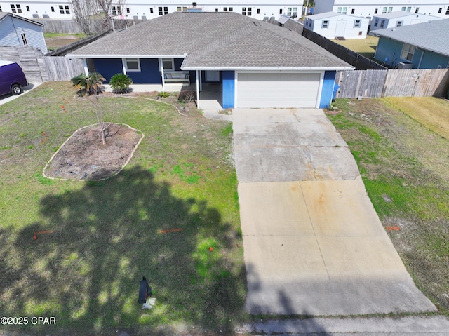 single story home with a front yard, concrete driveway, fence, and an attached garage