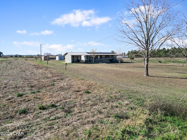 view of yard featuring an outdoor structure and an outbuilding