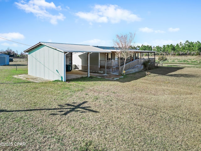 view of outdoor structure featuring an outbuilding and a carport