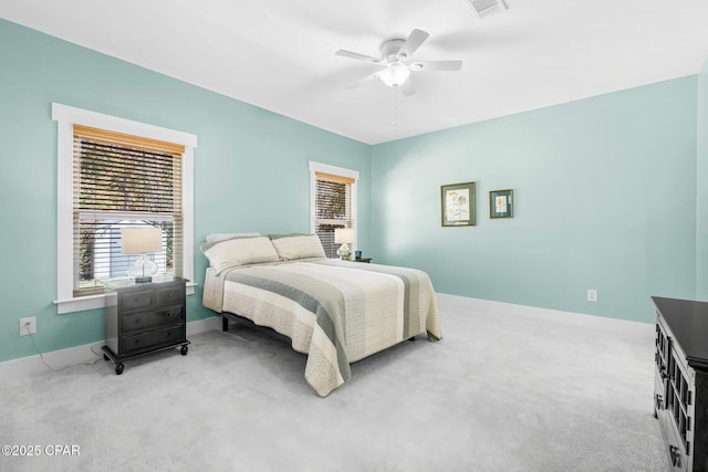 carpeted bedroom with a ceiling fan and baseboards