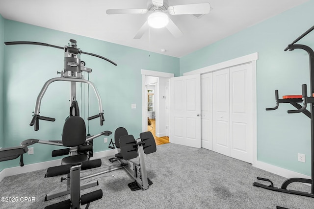 workout area with carpet floors, a ceiling fan, and baseboards