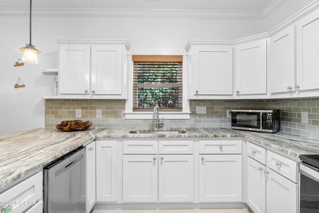 kitchen with stainless steel appliances, decorative backsplash, ornamental molding, white cabinetry, and a sink