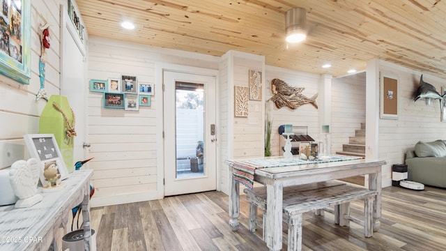 interior space featuring wooden walls, wood ceiling, stairway, wood finished floors, and recessed lighting