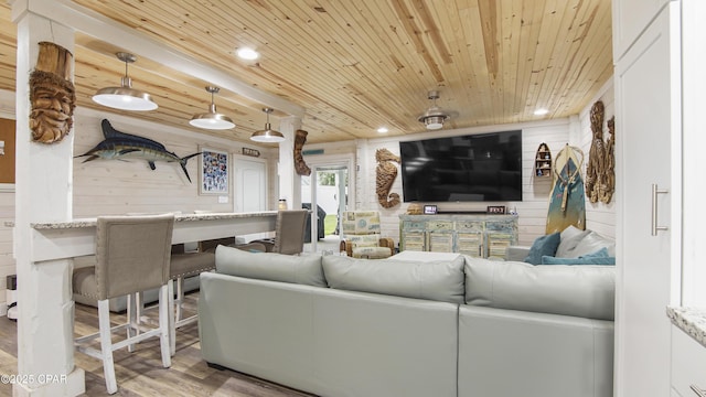 living room with recessed lighting, wood ceiling, wood walls, and wood finished floors