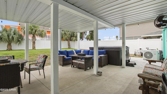 view of patio with ac unit, a hot tub, outdoor lounge area, and a fenced backyard