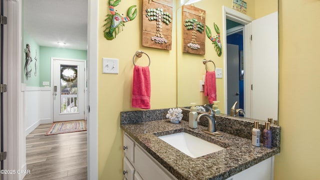 bathroom with vanity and wood finished floors