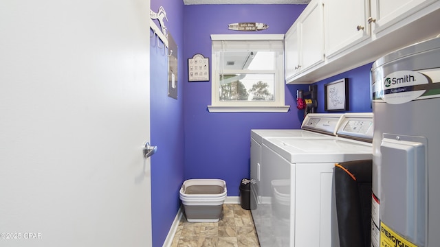 laundry room featuring cabinet space, water heater, baseboards, and washer and clothes dryer