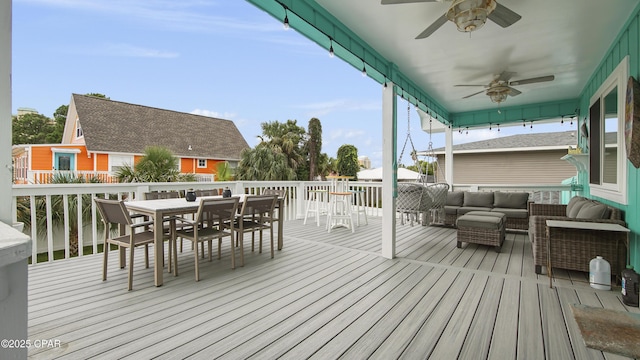 wooden terrace featuring outdoor dining space, outdoor lounge area, and a ceiling fan