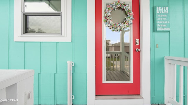 view of exterior entry featuring board and batten siding