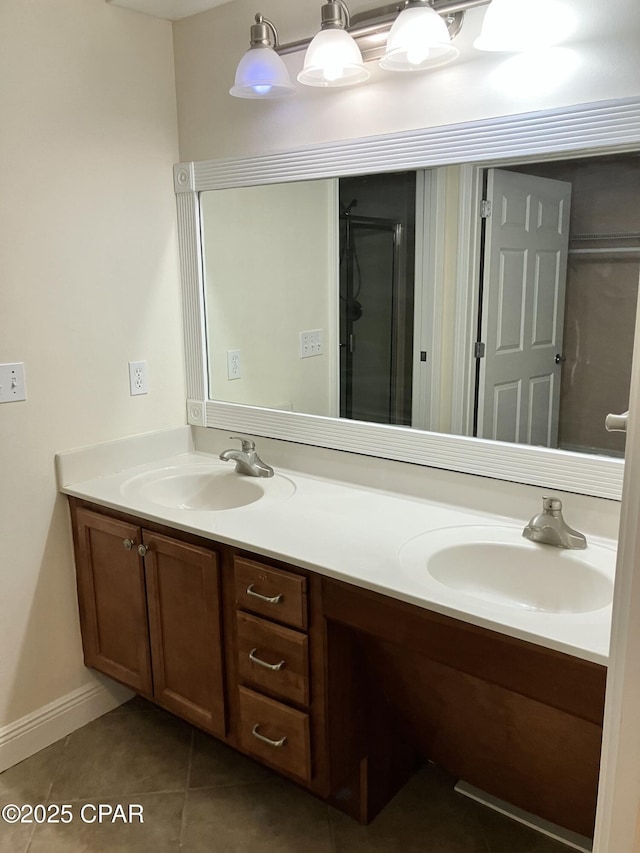 full bathroom with a shower with door, double vanity, tile patterned flooring, and a sink