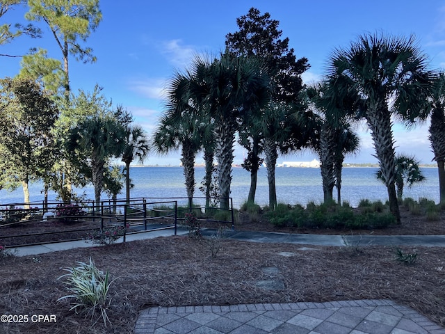 view of yard featuring a water view and fence
