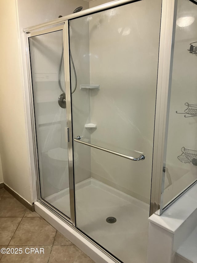 bathroom with tile patterned floors and a shower stall