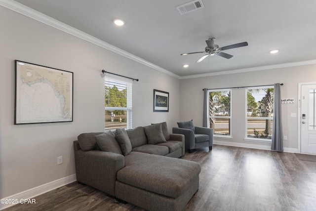 living area featuring baseboards, visible vents, ornamental molding, dark wood-style flooring, and recessed lighting